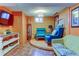 Finished basement with blue accent chairs and patterned flooring at 7970 Wolff Ct, Westminster, CO 80030