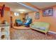 Finished basement with blue accent chairs and patterned flooring at 7970 Wolff Ct, Westminster, CO 80030