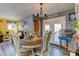 Dining room with hardwood floors, chandelier, and views of the backyard deck through French doors at 7970 Wolff Ct, Westminster, CO 80030