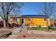 Charming single-story home with a brightly colored exterior, solar panels and well-maintained landscaping at 7970 Wolff Ct, Westminster, CO 80030