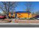 Charming single-story home with a brightly colored exterior, solar panels and well-maintained landscaping at 7970 Wolff Ct, Westminster, CO 80030