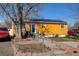 Charming single-story home with a brightly colored exterior, solar panels and well-maintained landscaping at 7970 Wolff Ct, Westminster, CO 80030