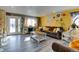 Bright living room with hardwood floors, brown couch, and large window for natural light at 7970 Wolff Ct, Westminster, CO 80030