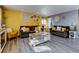 Open living room with hardwood floors, large windows, comfortable seating, and ample natural light at 7970 Wolff Ct, Westminster, CO 80030
