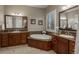 Bathroom features double sinks, granite counters, marble floors and a soaking tub for relaxation at 10693 Mountaingate Ct, Highlands Ranch, CO 80126