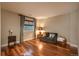 Cozy living room features hardwood floors, neutral-toned walls, sofa, and natural light for a relaxing space at 10693 Mountaingate Ct, Highlands Ranch, CO 80126