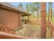 Backyard patio featuring a fenced-in yard, grassy area and stairs to deck at 29857 Park Village Dr, Evergreen, CO 80439