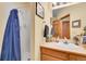 Bright bathroom with a shower, single sink vanity, and wood accents at 29857 Park Village Dr, Evergreen, CO 80439