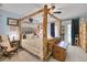 Bedroom featuring rustic four-poster bed, soft lighting, and cozy decor at 29857 Park Village Dr, Evergreen, CO 80439