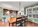 Open dining area showcasing hardwood floors, natural light, and stylish chandelier at 29857 Park Village Dr, Evergreen, CO 80439