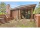 Comfortable outdoor patio seating area with wood siding and fencing at 29857 Park Village Dr, Evergreen, CO 80439