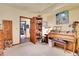 Inviting home office featuring a piano, bookshelf, and a view to other rooms at 29857 Park Village Dr, Evergreen, CO 80439