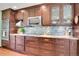 Modern kitchen features stainless steel appliances, custom cabinetry, and stylish backsplash at 29857 Park Village Dr, Evergreen, CO 80439