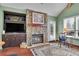Living room featuring a stone fireplace, built-in cabinets, and hardwood floors at 29857 Park Village Dr, Evergreen, CO 80439