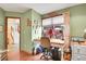 Bright home office with natural light, wooden desk, and built-in storage at 29857 Park Village Dr, Evergreen, CO 80439