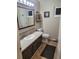A half bathroom featuring vanity with storage, a mirror, and a toilet at 36351 County Road 21, Elizabeth, CO 80107