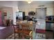 A kitchen featuring an island with seating, stainless appliances, and vintage backsplash at 36351 County Road 21, Elizabeth, CO 80107