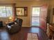 Living room boasts a comfortable recliner, wood floors, and a view to the outside at 36351 County Road 21, Elizabeth, CO 80107