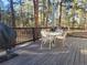 Cozy outdoor deck features a dining table and seating, perfect for enjoying the surrounding wooded scenery at 36351 County Road 21, Elizabeth, CO 80107