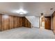This basement has carpet, storage closets, and access to the laundry area at 53 S Eagle Cir, Aurora, CO 80012