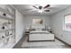 This bedroom is fully furnished, showcasing a comfortable bed and a built-in bookshelf for storage at 53 S Eagle Cir, Aurora, CO 80012
