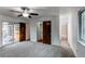 The bedroom offers outdoor access, a closet, and an adjoining bathroom with neutral gray carpeting at 53 S Eagle Cir, Aurora, CO 80012