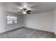 Bright bedroom with ceiling fan, neutral carpet and large window at 53 S Eagle Cir, Aurora, CO 80012