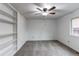 Clean bedroom with a ceiling fan and a window overlooking the backyard at 53 S Eagle Cir, Aurora, CO 80012