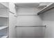 A walk-in closet provides ample storage with shelving and metal hanging rods at 53 S Eagle Cir, Aurora, CO 80012