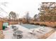 Community pool area with lounge chairs and tables surrounded by mature trees at 53 S Eagle Cir, Aurora, CO 80012