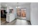 Bright dining area with view of patio, wooden table and seating, and modern floors at 53 S Eagle Cir, Aurora, CO 80012