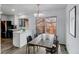 Bright dining area with table, chairs, and access to kitchen and outdoor space at 53 S Eagle Cir, Aurora, CO 80012