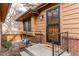 Charming front entrance with decorative iron security door, brick accents, and a welcome mat at 53 S Eagle Cir, Aurora, CO 80012