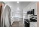 Kitchen with stainless appliances, modern countertops, and gray flooring next to dining area at 53 S Eagle Cir, Aurora, CO 80012