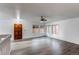 Open living area with dark wood door, gray woodgrain floors, and large windows for natural light at 53 S Eagle Cir, Aurora, CO 80012