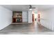 Spacious living room with a fireplace, built-in shelving, and access to other parts of the home at 53 S Eagle Cir, Aurora, CO 80012