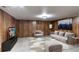 This living room has wooden walls, neutral gray furniture, and a modern style at 53 S Eagle Cir, Aurora, CO 80012
