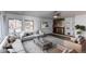 Staged living room with modern furnishings, fireplace, and large windows for plenty of natural light at 53 S Eagle Cir, Aurora, CO 80012