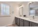 Bathroom with double vanity, updated lighting and a shower/tub combo with neutral tones at 112 W Sterne Pkwy, Littleton, CO 80120