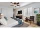 Modern staged bedroom with wood floors, plantation shutters, ceiling fan, and decorative plants at 112 W Sterne Pkwy, Littleton, CO 80120