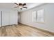 Bedroom with sliding closet doors, ceiling fan, and a window with plantation shutters at 112 W Sterne Pkwy, Littleton, CO 80120