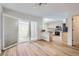 Stylish dining area with wood flooring, open to kitchen and natural light flowing from adjacent patio at 112 W Sterne Pkwy, Littleton, CO 80120