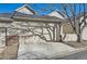 Attached two-car garage featuring a concrete driveway and brick facade at 112 W Sterne Pkwy, Littleton, CO 80120