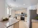 Modern kitchen with stainless steel appliances, granite countertops, tile backsplash and ample cabinet space at 112 W Sterne Pkwy, Littleton, CO 80120