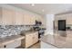 Modern kitchen featuring stainless steel appliances, granite countertops, stylish backsplash, and ample cabinet space at 112 W Sterne Pkwy, Littleton, CO 80120