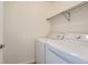 Laundry room with a standard washer and dryer and a hanging bar for clothes at 112 W Sterne Pkwy, Littleton, CO 80120