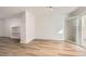 Bright living room featuring hardwood floors, built-in shelving, and sliding glass door with shutters at 112 W Sterne Pkwy, Littleton, CO 80120