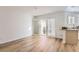 Bright living room featuring hardwood floors and a sliding glass door with white shutters at 112 W Sterne Pkwy, Littleton, CO 80120