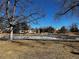 Frozen pond surrounded by residential buildings, playgrounds, and grass at 112 W Sterne Pkwy, Littleton, CO 80120