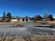 Pond surrounded by residential buildings and a playground in the distance at 112 W Sterne Pkwy, Littleton, CO 80120